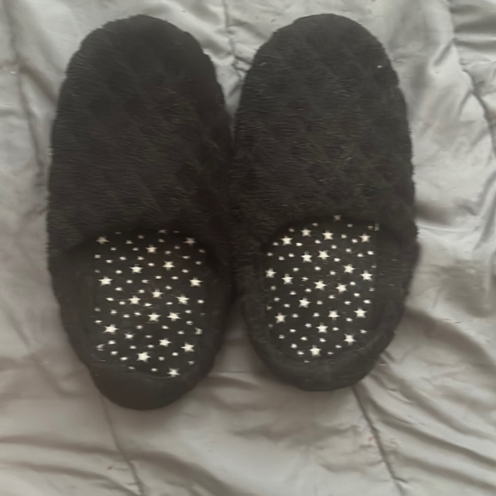 black slippers with star designs